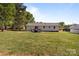 Spacious backyard featuring a covered parking area and a small deck perfect for outdoor gatherings at 1238 Moss Springs Rd, Albemarle, NC 28001