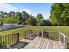 View of the backyard from the wooden deck with railing, perfect for relaxing and enjoying the outdoors at 1238 Moss Springs Rd, Albemarle, NC 28001