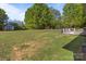 Large backyard with mature trees, ample green space, a shed, a playset and plenty of room for outdoor activities at 1238 Moss Springs Rd, Albemarle, NC 28001