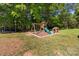 Playground set with slide and a small playhouse in a spacious backyard at 1238 Moss Springs Rd, Albemarle, NC 28001