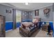Baseball themed bedroom featuring gray and blue walls with a wood bed frame at 1238 Moss Springs Rd, Albemarle, NC 28001