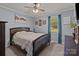 Bedroom with a ceiling fan, neutral walls, and a large window overlooking the backyard at 1238 Moss Springs Rd, Albemarle, NC 28001