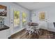 Sunlit dining room with table and chairs, and a view to the backyard at 1238 Moss Springs Rd, Albemarle, NC 28001