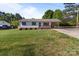 Charming home with well-maintained front yard, covered parking, and inviting porch seating at 1238 Moss Springs Rd, Albemarle, NC 28001