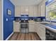 Well-lit kitchen with stainless steel appliances, and blue accent wall at 1238 Moss Springs Rd, Albemarle, NC 28001