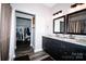 Modern bathroom with dual sinks, granite countertops, and wood-look floors at 129 Devon Dr, Heath Springs, SC 29058