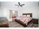 Cozy bedroom with a ceiling fan, window, and dark wood furniture at 129 Devon Dr, Heath Springs, SC 29058