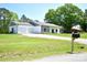 Property featuring a two-car garage and a long gravel driveway at 129 Devon Dr, Heath Springs, SC 29058
