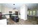 Bright kitchen featuring stainless appliances, a large island, and modern finishes with hardwood style floors at 129 Devon Dr, Heath Springs, SC 29058