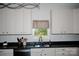 Bright kitchen featuring light cabinets and a window over the sink at 129 Devon Dr, Heath Springs, SC 29058