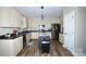 Kitchen featuring stainless appliances, a large island, modern finishes, and hardwood style floors at 129 Devon Dr, Heath Springs, SC 29058