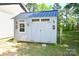 An outbuilding with a metal roof, multiple windows, barn style doors and vintage lamps at 129 Devon Dr, Heath Springs, SC 29058
