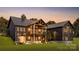 Elegant modern farmhouse-style home with a covered porch, and a landscaped yard at 181 Asbury Cir, Mooresville, NC 28117