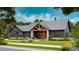 Attractive modern farmhouse-style home with a covered porch and beautiful landscaping at 181 Asbury Cir, Mooresville, NC 28117