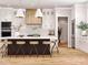 Modern kitchen with white cabinetry, wooden accents, a large island, and state-of-the-art appliances at 181 Asbury Cir, Mooresville, NC 28117