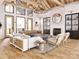 Bright living room featuring high ceilings, wood beams, and a cozy fireplace for a warm and inviting atmosphere at 181 Asbury Cir, Mooresville, NC 28117