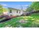 Backyard view of a home with a grassy lawn, a deck, and a well-maintained yard with mature trees at 13817 Kings Carriage Ln, Charlotte, NC 28278