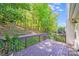 Inviting backyard featuring a well-maintained deck overlooking lush landscaping and mature trees at 13817 Kings Carriage Ln, Charlotte, NC 28278