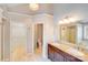 Bathroom with dual sink vanity, stylish lighting and multiple doors at 13817 Kings Carriage Ln, Charlotte, NC 28278