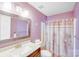 Bathroom with pink walls, shower, toilet, and mirror over a vanity with a sink at 13817 Kings Carriage Ln, Charlotte, NC 28278