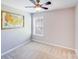 Simple bedroom with a map decoration hanging over the bed, and a window with a view at 13817 Kings Carriage Ln, Charlotte, NC 28278