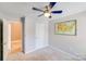 Bedroom with gray walls, ceiling fan, and a framed map on the wall at 13817 Kings Carriage Ln, Charlotte, NC 28278