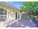A wooden deck with string lights, plants, and a view of the backyard and trees at 13817 Kings Carriage Ln, Charlotte, NC 28278