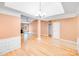 Dining area featuring hardwood floors, stylish lighting, and wainscoting at 13817 Kings Carriage Ln, Charlotte, NC 28278