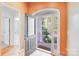 Bright foyer with decorative glass front door and views to the front yard and staircase at 13817 Kings Carriage Ln, Charlotte, NC 28278