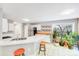 Bright eat-in kitchen featuring stainless steel appliances, bar seating and bright lighting at 13817 Kings Carriage Ln, Charlotte, NC 28278