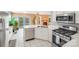 The kitchen is equipped with stainless steel appliances and modern fixtures at 13817 Kings Carriage Ln, Charlotte, NC 28278