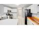The kitchen features sleek stainless-steel appliances, light cabinets and an open floor plan at 13817 Kings Carriage Ln, Charlotte, NC 28278