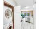 Bright laundry room features a stacked washer and dryer for convenience, with easy access to the main area at 13817 Kings Carriage Ln, Charlotte, NC 28278