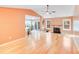 Open living room with hardwood floors, fireplace, and views to the patio at 13817 Kings Carriage Ln, Charlotte, NC 28278