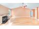 Bright, open living room with light hardwood floors and a cozy fireplace adding warmth to the space at 13817 Kings Carriage Ln, Charlotte, NC 28278