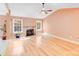Bright living room features hardwood floors, a fireplace, and large windows offering natural light at 13817 Kings Carriage Ln, Charlotte, NC 28278