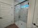 Modern bathroom featuring a frameless glass shower with stylish marble-look tile and black fixtures at 142 Prestwick Way # 18, Mooresville, NC 28115