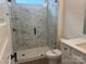 Bathroom featuring a frameless glass shower with stylish marble-look tile and modern black fixtures at 142 Prestwick Way # 18, Mooresville, NC 28115