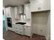 Modern kitchen with white cabinets, sleek black hardware, stainless steel appliances and tiled backsplash at 142 Prestwick Way # 18, Mooresville, NC 28115