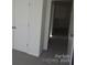 Bedroom with closet with white doors and view into the hallway, carpeted floor at 148 Kodak Dr, Statesville, NC 28625