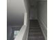 Well-lit staircase with carpeted steps for safe and easy access between floors at 149 Kodak Dr, Statesville, NC 28625