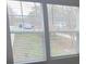 Window with blinds overlooking the neighborhood street with trees at 149 Kodak Dr, Statesville, NC 28625