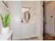 Bright bathroom featuring stylish vanity with storage and oval mirror at 1501 Briarfield Dr, Charlotte, NC 28205