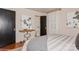 This bedroom features warm hardwood floors and modern decor with artwork on the wall and black doors at 1501 Briarfield Dr, Charlotte, NC 28205