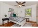 Charming bedroom featuring a whimsical dinosaur theme with a bed, side table, and window overlooking the outdoors at 1501 Briarfield Dr, Charlotte, NC 28205