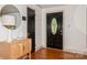 Light and airy entryway features hardwood floors, decorative mirror and a stylish front door at 1501 Briarfield Dr, Charlotte, NC 28205