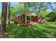 Cozy brick house with a manicured lawn, complete with a charming front porch and an American flag at 1501 Briarfield Dr, Charlotte, NC 28205