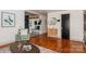 Open-concept living room with hardwood floors, natural light, custom storage, and stylish furnishings at 1501 Briarfield Dr, Charlotte, NC 28205