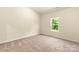 Bright bedroom featuring neutral walls, plush carpet, and a sunlit window at 1550 Doran Ter, Richburg, SC 29729