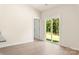 Living room featuring a sliding glass door to backyard, white trim, and neutral paint at 1550 Doran Ter, Richburg, SC 29729